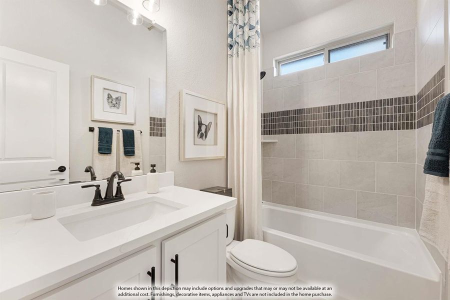 Bathroom with white vanity, tiled tub-shower combo, and decorative mosaic accent strip