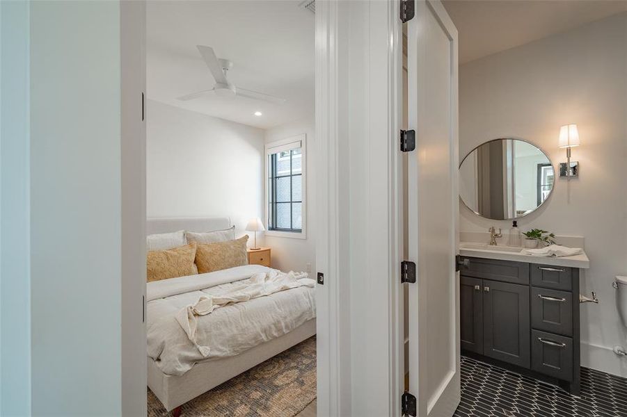 Bedroom with ceiling fan and sink