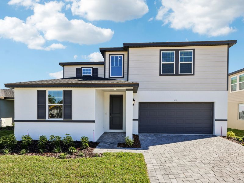 Front exterior of a new home in The Reserve at Hammock Oaks - Signature Series, Lady Lake, FL, highlighting curb appeal (Image 1).