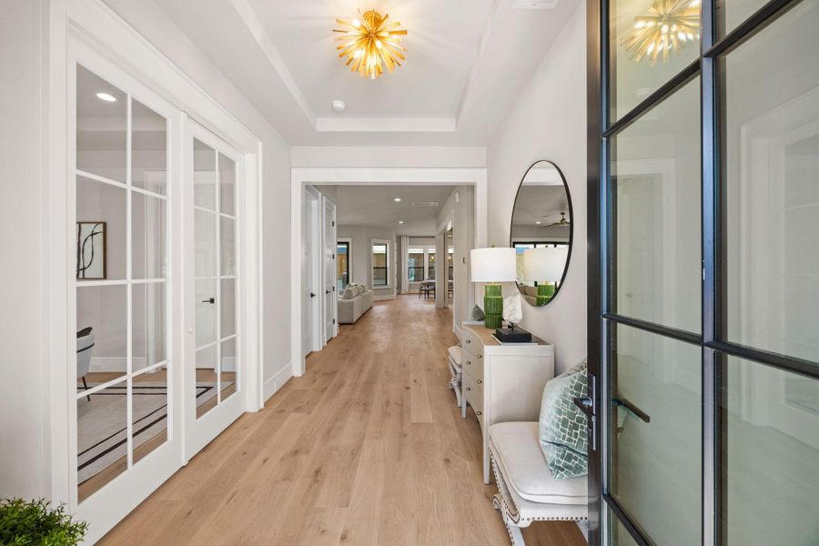 Guests are greeted w/ a metal/glass front door, white oak wood floors & trayed ceiling w/ designer selected fixture. 1st Floor Study is off to the left w/ double door entrance & dual entrance full bathroom.