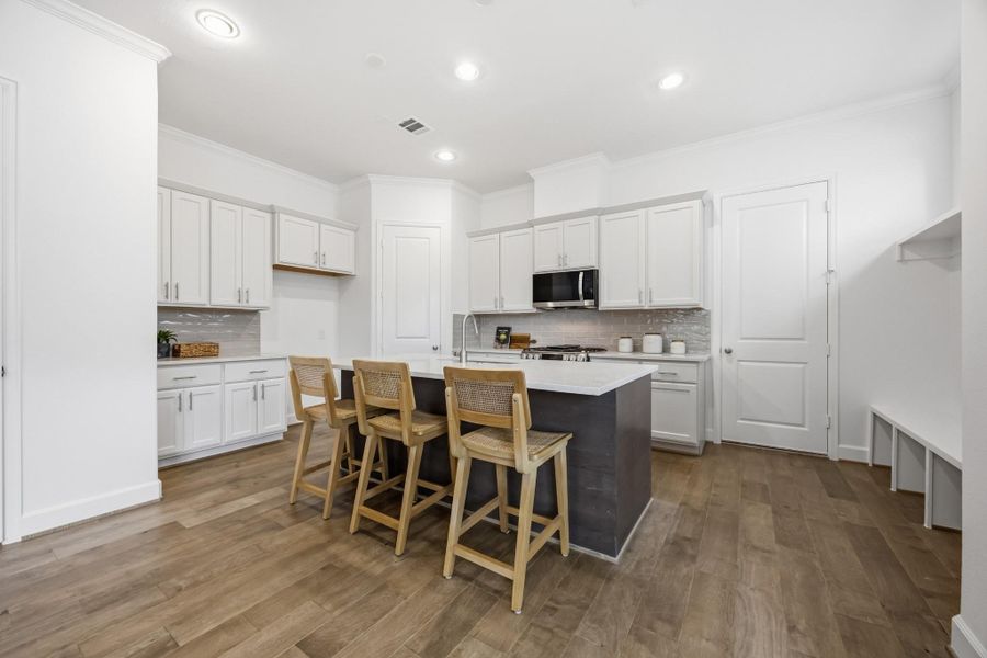 Culinary Paradise: A chef's dream kitchen awaits, featuring direct garage access for seamless transitions from car to culinary creation.