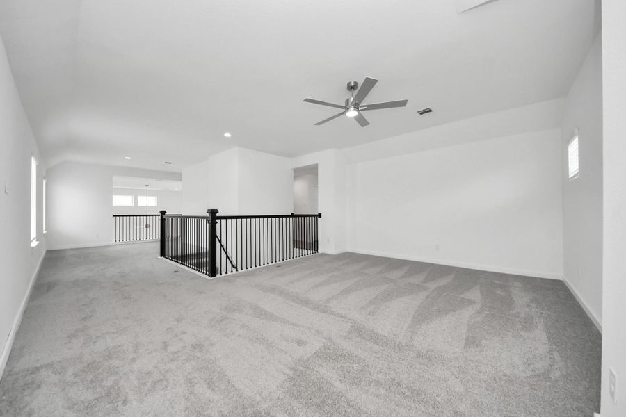 Come upstairs and enjoy a day of leisure in this fabulous game room! This is the perfect hangout spot or adult game room! Features plush carpet, high ceilings, custom paint and windows for plenty of natural light. Sample photo of completed home with similar floor plan. Actual colors and selections may vary. Come upstairs and enjoy a day of leisure in this fabulous game room! This is the perfect hangout spot or adult game room! Features plush carpet, high ceilings, custom paint and windows for plenty of natural light. Sample photo of completed home with similar floor plan. Actual colors and selections may vary.