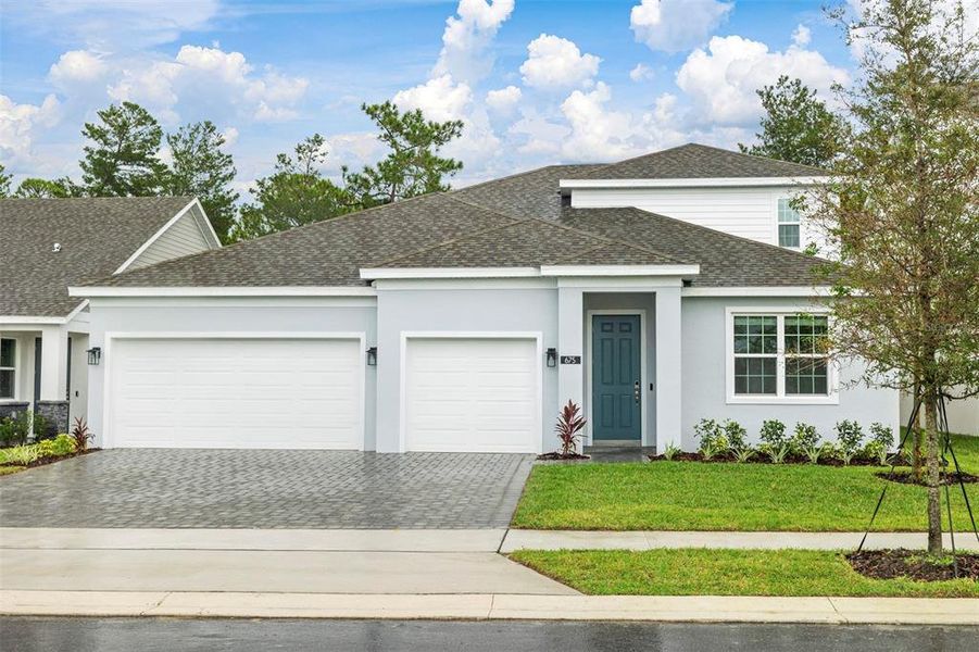 Front exterior of a new home in Trinity Gardens, Deland, FL, highlighting curb appeal (Image 1). Front exterior of a new home in Trinity Gardens, Deland, FL, highlighting curb appeal (Image 1).