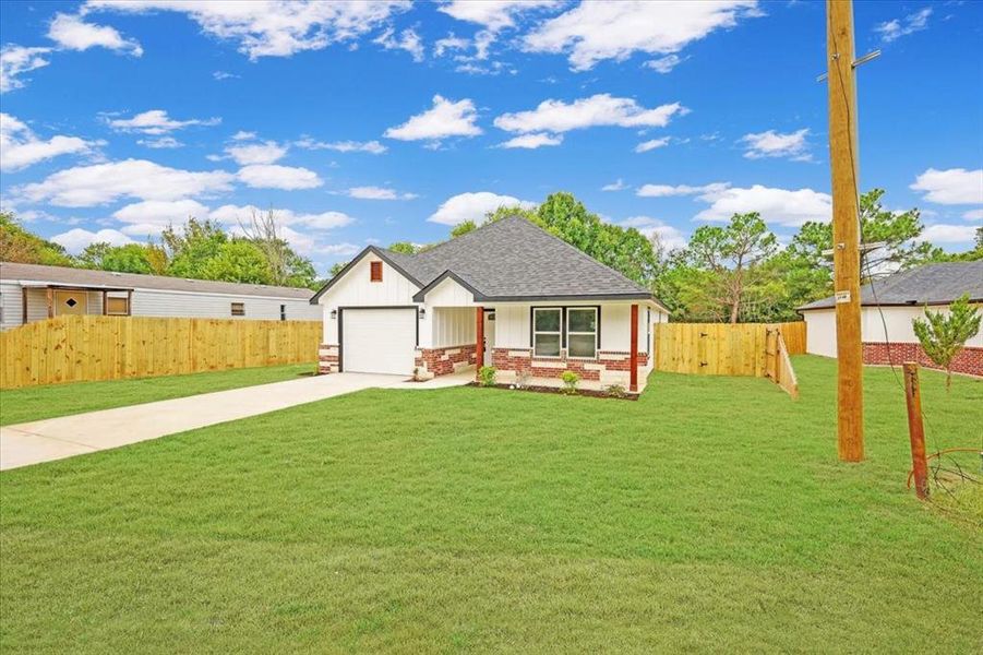 View of front of home featuring driveway, roof with shingles, board and batten siding, covered porch, and brick siding View of front of home featuring driveway, roof with shingles, board and batten siding, covered porch, and brick siding