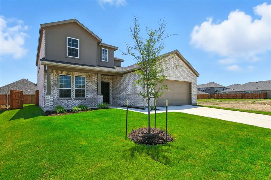 Traditional-style home with driveway, an attached garage, and brick siding Traditional-style home with driveway, an attached garage, and brick siding