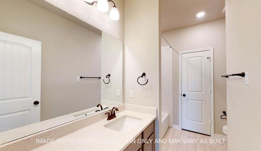 Full bath with vanity, shower / bath combination, light tile patterned flooring, and recessed lighting Full bath with vanity, shower / bath combination, light tile patterned flooring, and recessed lighting
