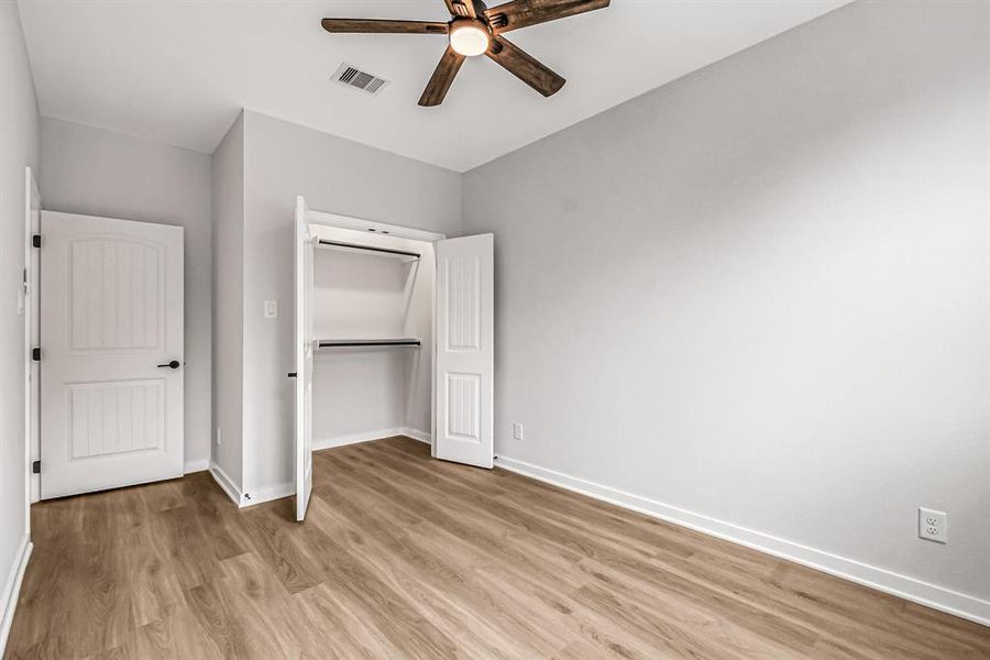 Spacious closet with plenty of hanging space in the guest bedroom.