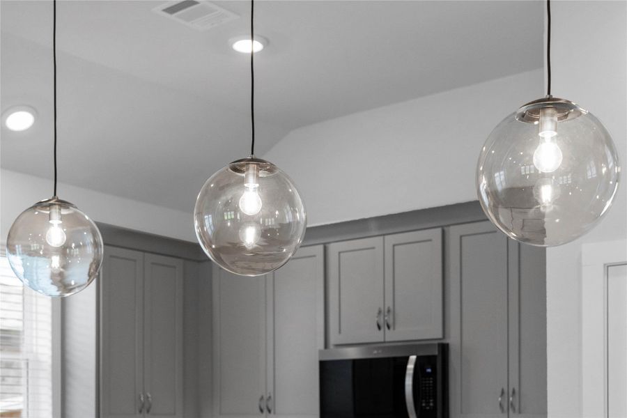 Atwell Brushed Nickel pendant lights that hang over the kitchen island. Atwell Brushed Nickel pendant lights that hang over the kitchen island.