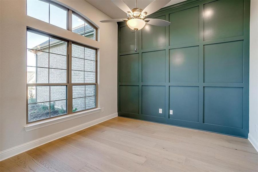 Unfurnished room featuring light hardwood / wood-style floors, a wealth of natural light, and ceiling fan