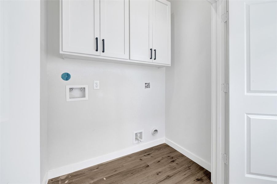 Dedicated laundry with shelving and utility connections. Dedicated laundry with shelving and utility connections.