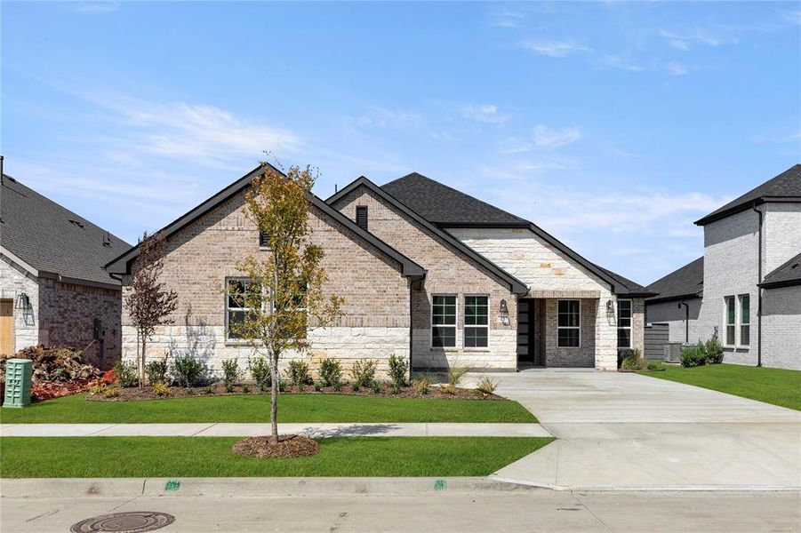 Front exterior of a new home in Inspiration Collection at Union Park, Little Elm, TX, highlighting curb appeal (Image 1).