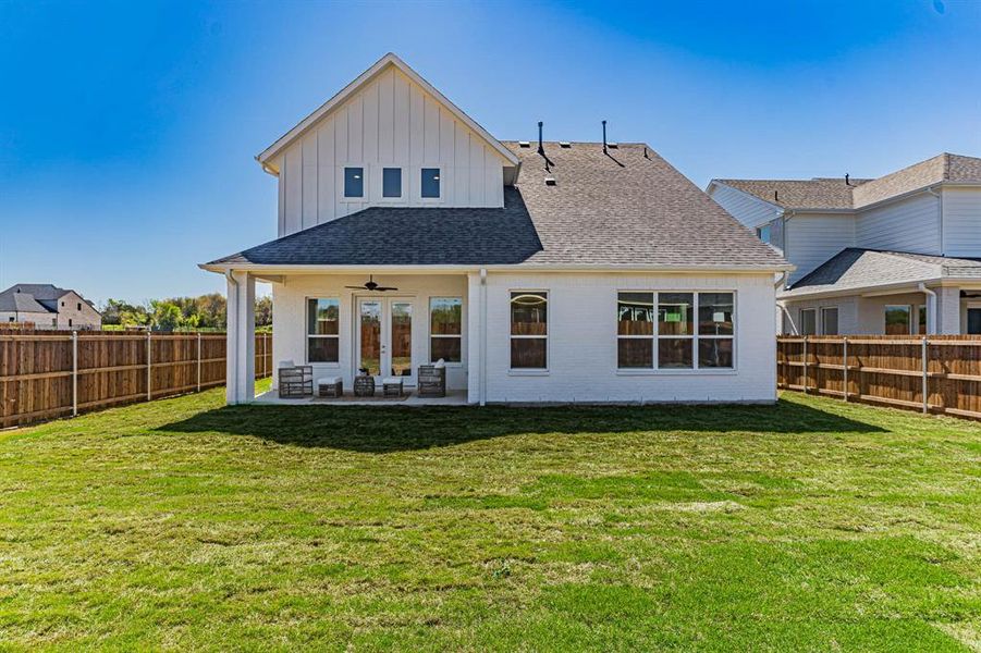 Back of house featuring a patio and a yard