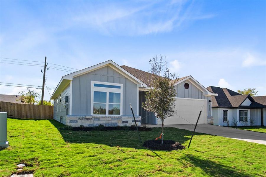 Single story home featuring a garage and concrete driveway Single story home featuring a garage and concrete driveway