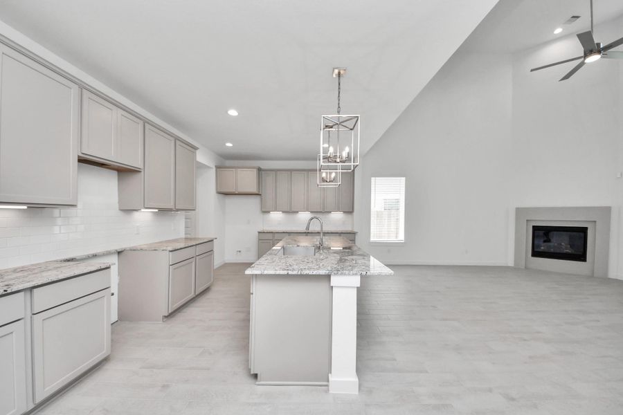 This kitchen is by far any chef’s dream! This spacious kitchen features high ceilings, light stained wood cabinets, granite countertop, SS appliances, modern tile backsplash, recessed lighting, extended counter space, granite kitchen island with double sink, and space for breakfast bar, and a walk-in pantry all overlooking your huge family room. Sample photo of completed home with similar floor plan. Actual colors and selections may vary.