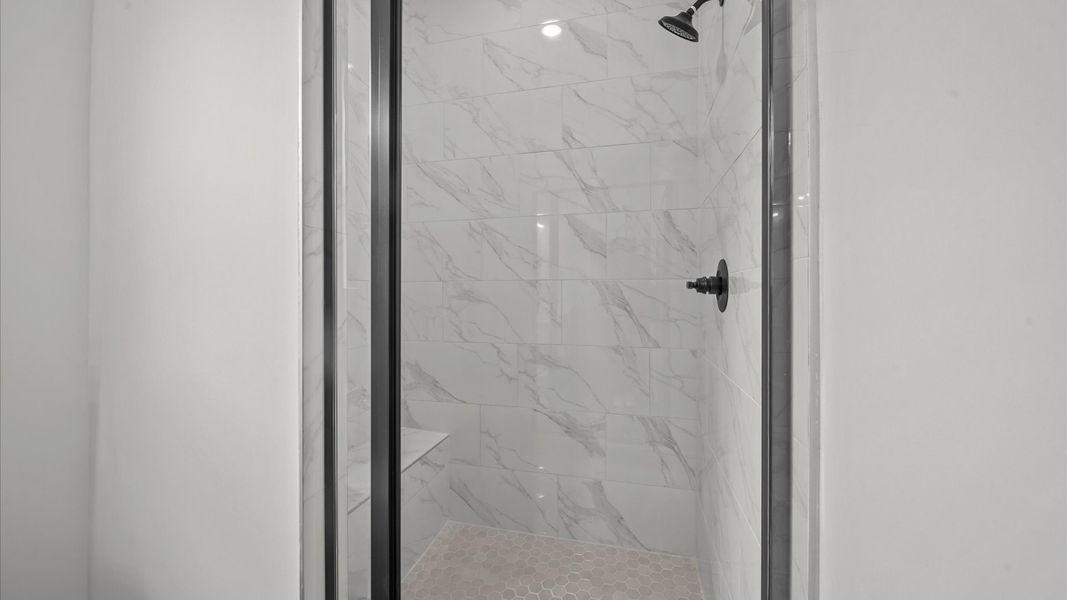 Highly functional and elegant en-suite with dual vanities, tiled walk-in shower, and refined finishes