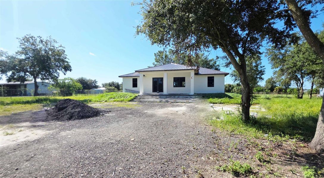 Front exterior of a new home in , Clewiston, FL, highlighting curb appeal (Image 8).