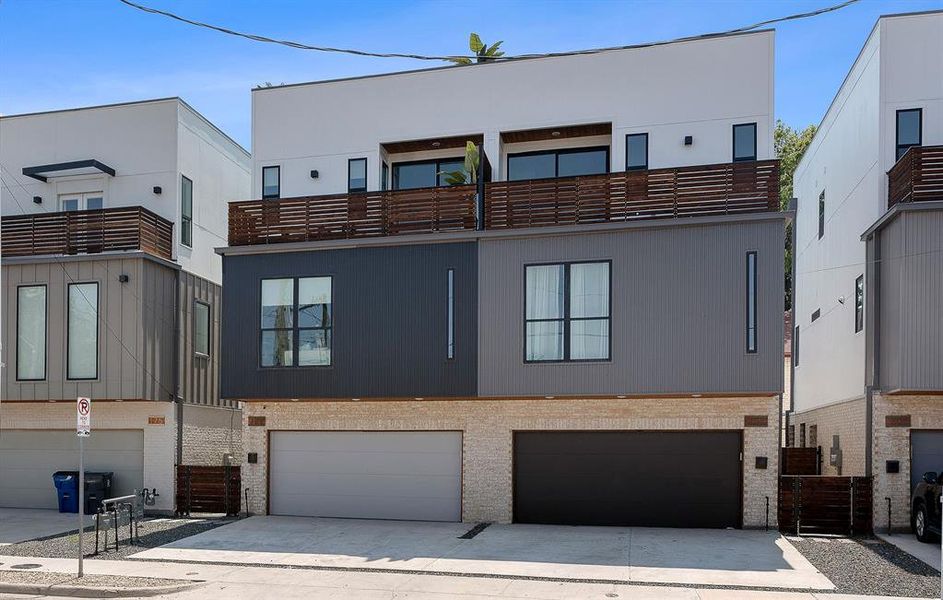 Back of house featuring concrete driveway and an attached garage Back of house featuring concrete driveway and an attached garage