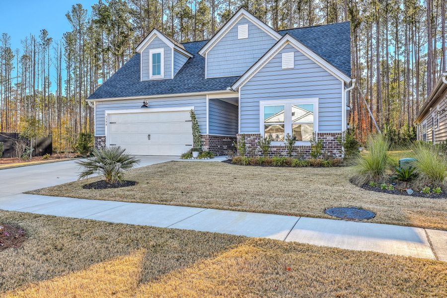 Front exterior of a new home in Horizons at Summers Corner | 55+: The Legends, Summerville, SC, highlighting curb appeal (Image 2).