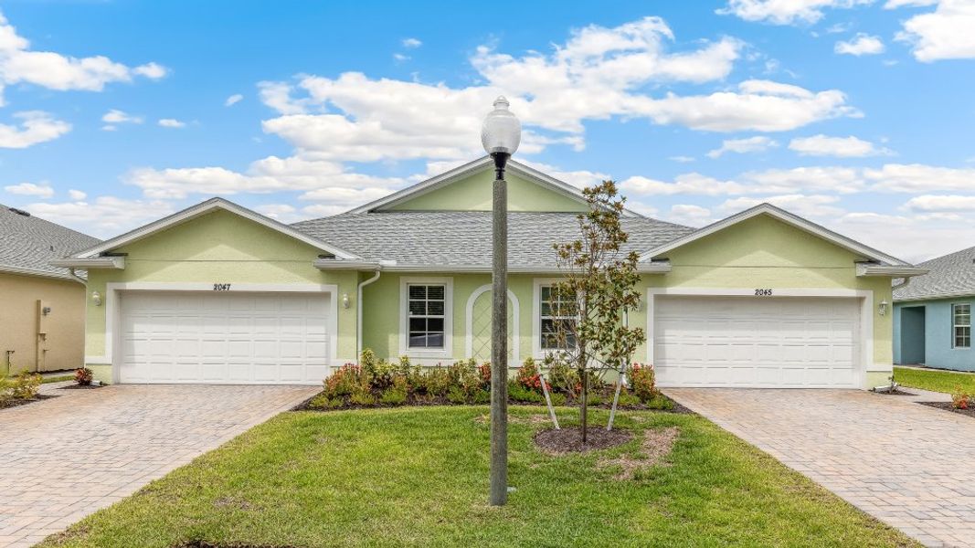 Front exterior of a new home in Heritage Lake Park, Punta Gorda, FL, highlighting curb appeal (Image 1).