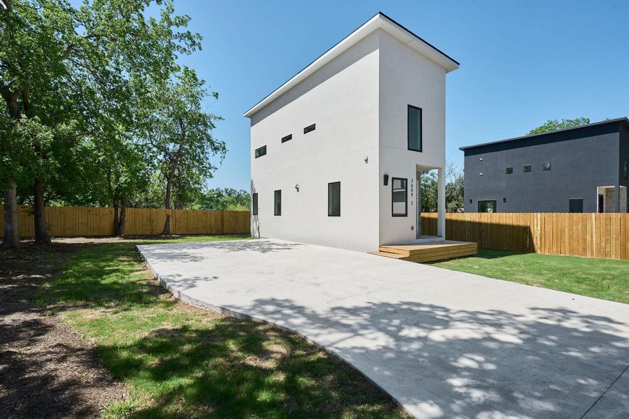 Back of house with a patio, a yard, stucco siding, and fence
