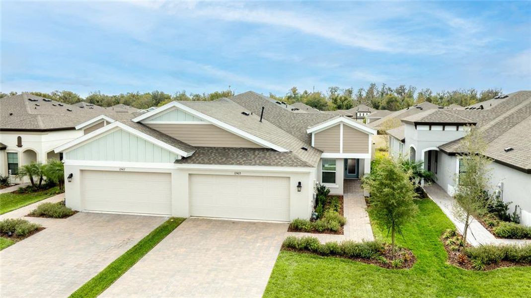 Front exterior of a new home in Crosswind Point, Parrish, FL, highlighting curb appeal (Image 19).