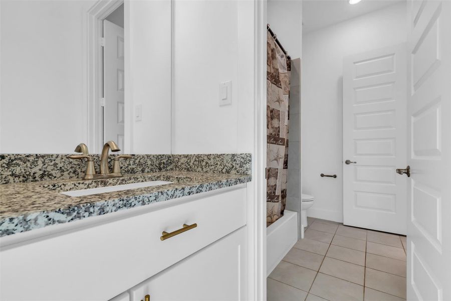 Jack & Jill Bathroom:One of the few Jack and Jill baths in the home, this thoughtfully designed space connects two upstairs bedrooms with style and convenience. Featuring dual access, granite finishes, and modern fixtures, it balances privacy with practicality in a refined way.