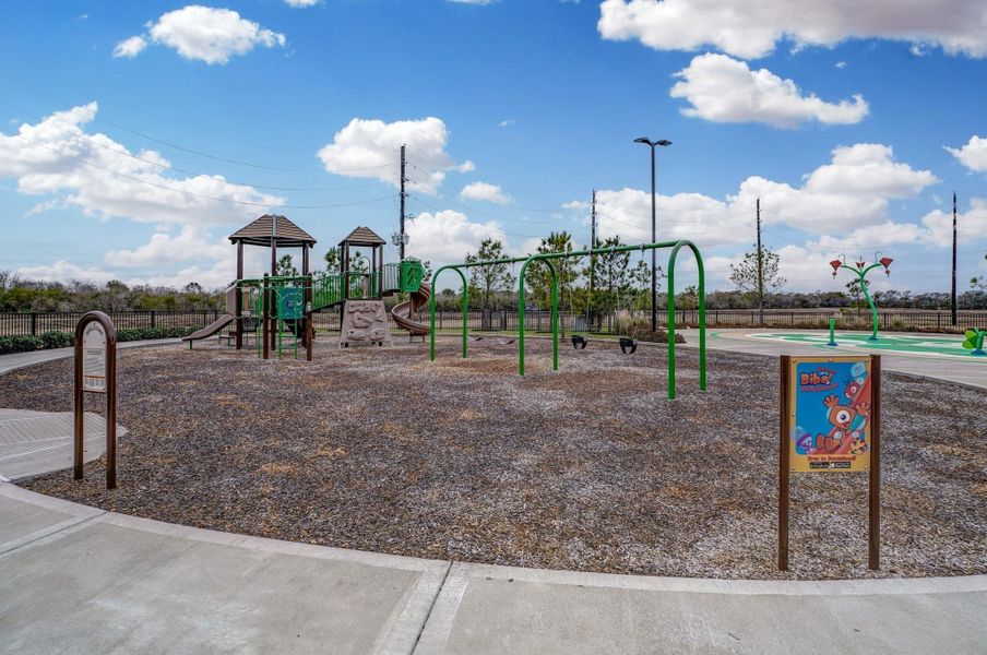 Family-friendly community park featuring a playground with slides, swings, and a play area. Ideal for children and outdoor activities, surrounded by a safe, well-maintained environment.