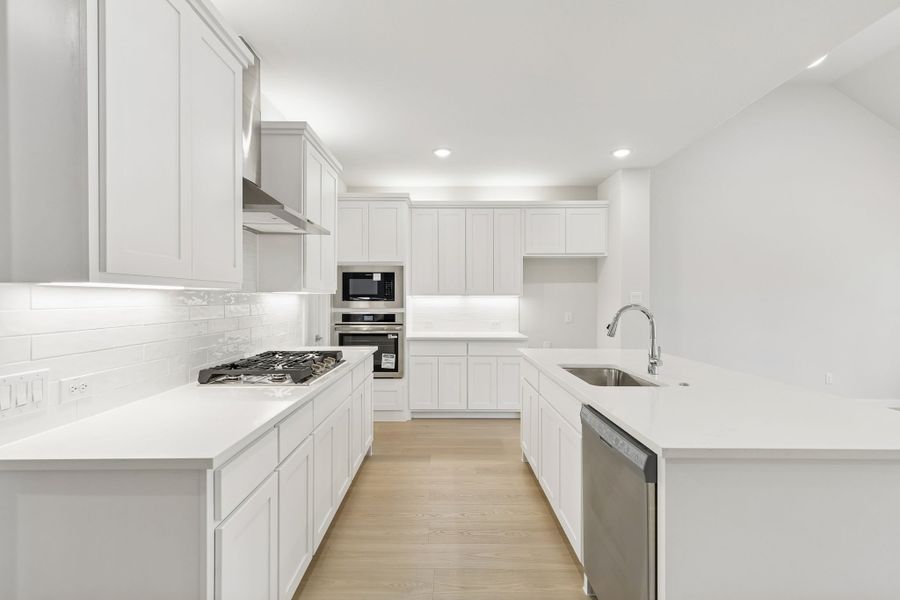 Kitchen in the Masters home plan by Trophy Signature Homes – REPRESENTATIVE PHOTO