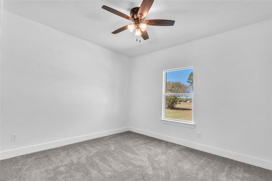 Carpeted 2nd Bedroom featuring lighted ceiling fan Carpeted 2nd Bedroom featuring lighted ceiling fan