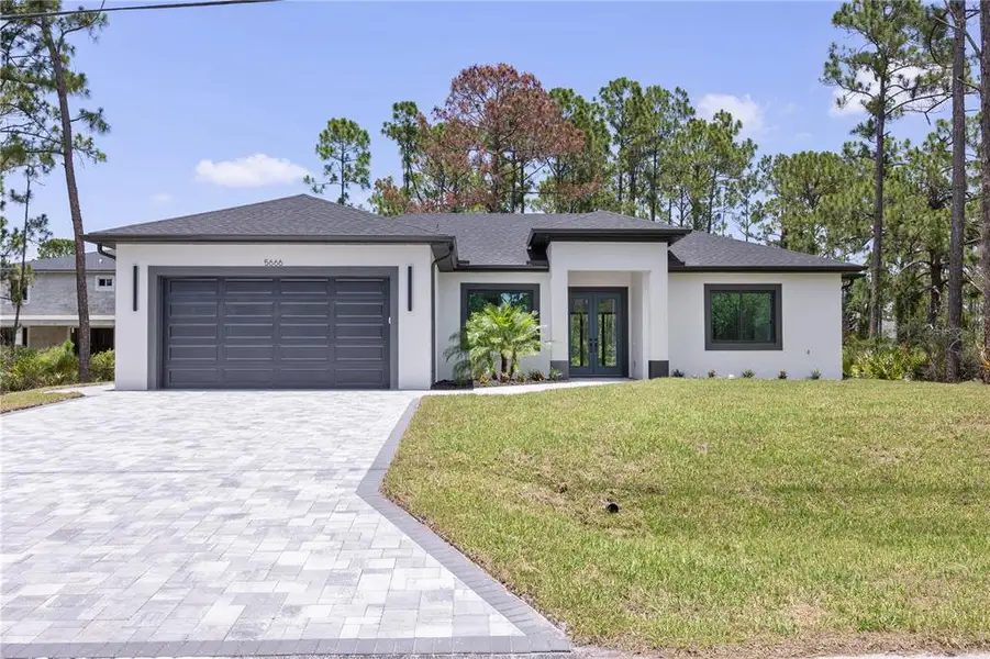 Front exterior of a new home in , North Port, FL, highlighting curb appeal (Image 1). Front exterior of a new home in , North Port, FL, highlighting curb appeal (Image 1).