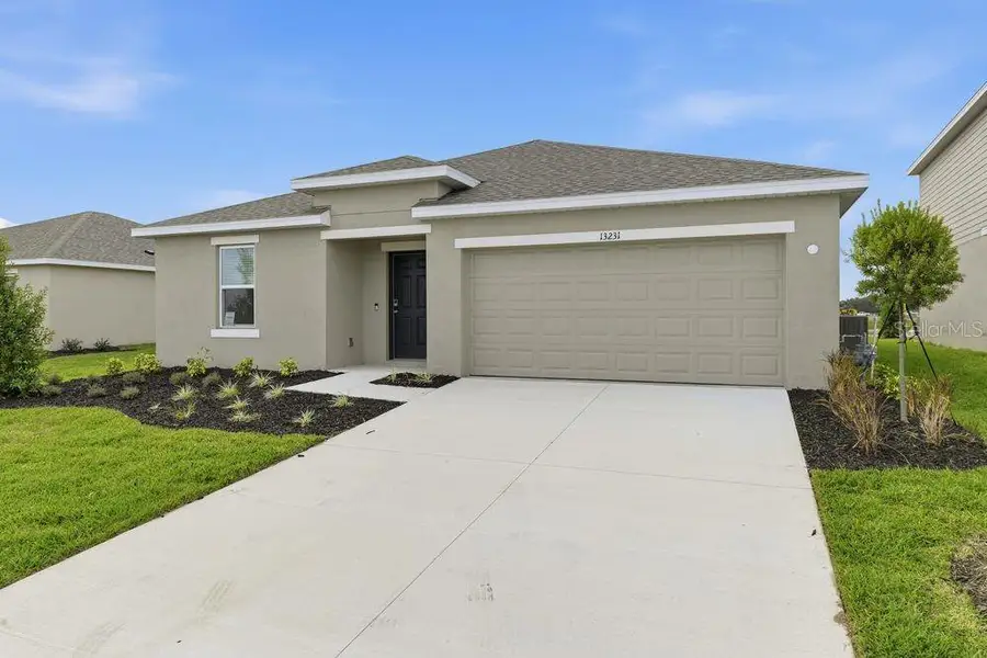Front exterior of a new home in Firethorn, Parrish, FL, highlighting curb appeal (Image 1).