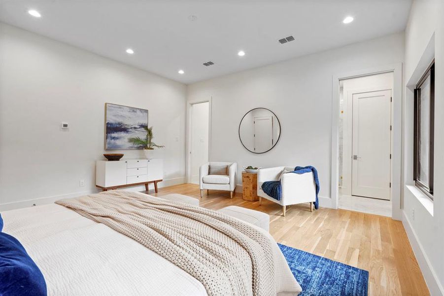Bedroom with light wood finished floors and recessed lighting Bedroom with light wood finished floors and recessed lighting