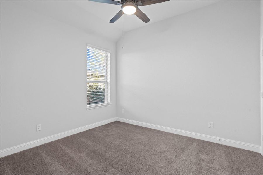 This bright secondary bedroom presents a versatile and neutral space, ideal for a guest room, home office, or quiet retreat. This bright secondary bedroom presents a versatile and neutral space, ideal for a guest room, home office, or quiet retreat.