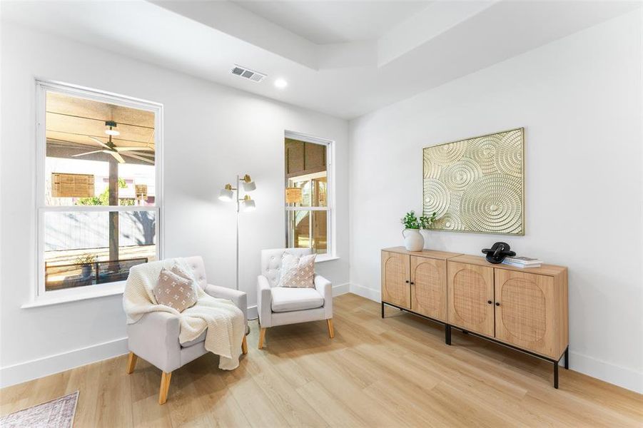 Living area featuring light wood-type flooring, plenty of natural light, and recessed lighting