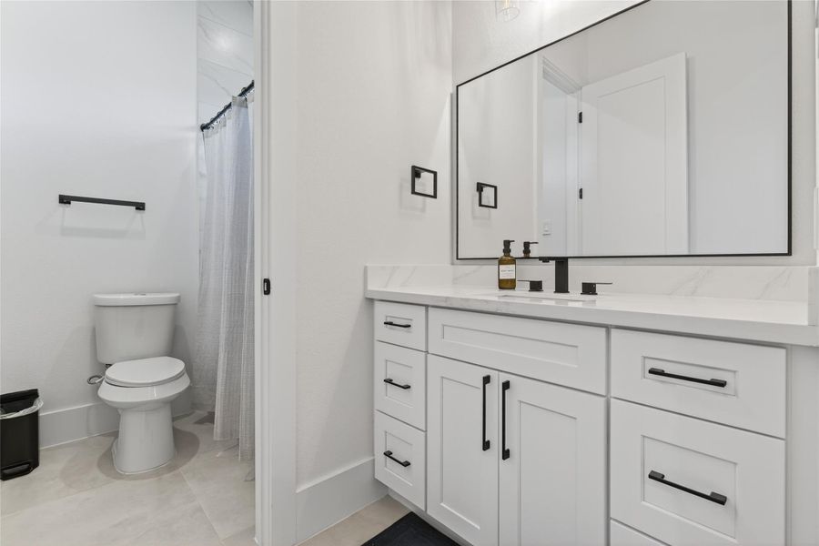 Another secondary bath offers generous cabinetry, modern fixtures, and a clean, functional layout. **Images are from a previously completed project. **