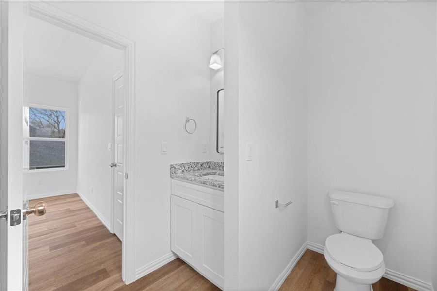 Private primary bathroom featuring granite countertop vanity, modern fixtures, and clean, bright finishes.