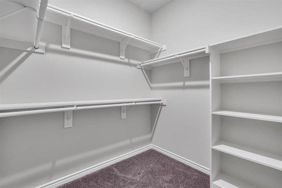 Walk in closet in primary bedroom.