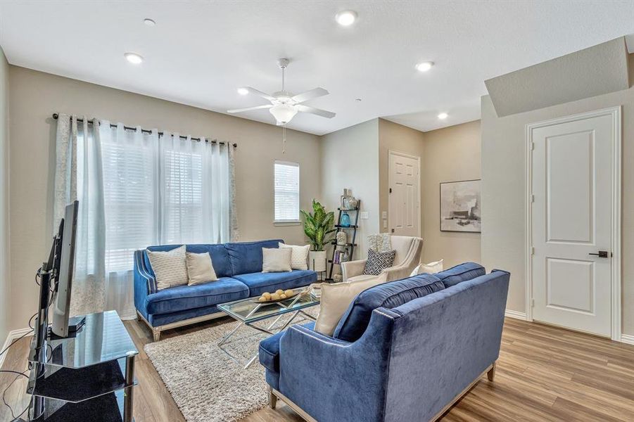 Living room featuring ceiling fan and light wood-type flooring