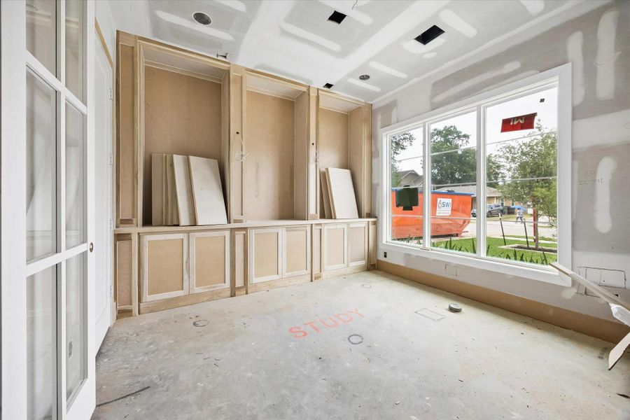 Dedicated first floor study framed by custom site built cabinetry and a large Low E window for natural light. Designed for focus and storage with recessed lighting and Level 4 smooth walls for a clean modern finish. Dedicated first floor study framed by custom site built cabinetry and a large Low E window for natural light. Designed for focus and storage with recessed lighting and Level 4 smooth walls for a clean modern finish.