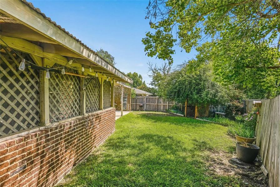 Expansive backyard featuring a manicured lawn, established perimeter fencing, and mature trees Expansive backyard featuring a manicured lawn, established perimeter fencing, and mature trees