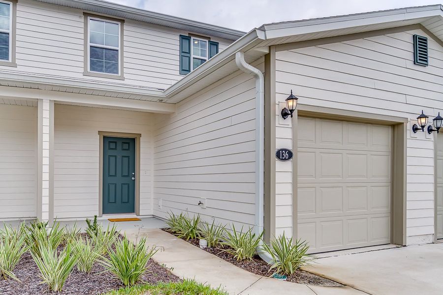 Front exterior of a home in the Orchard Park Townhomes community, located in St. Augustine, FL (Image 4).