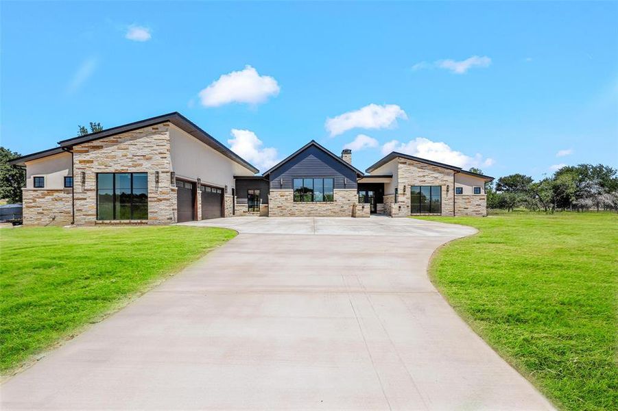 Front exterior of a new home in , Strawn, TX, highlighting curb appeal (Image 19). Front exterior of a new home in , Strawn, TX, highlighting curb appeal (Image 19).