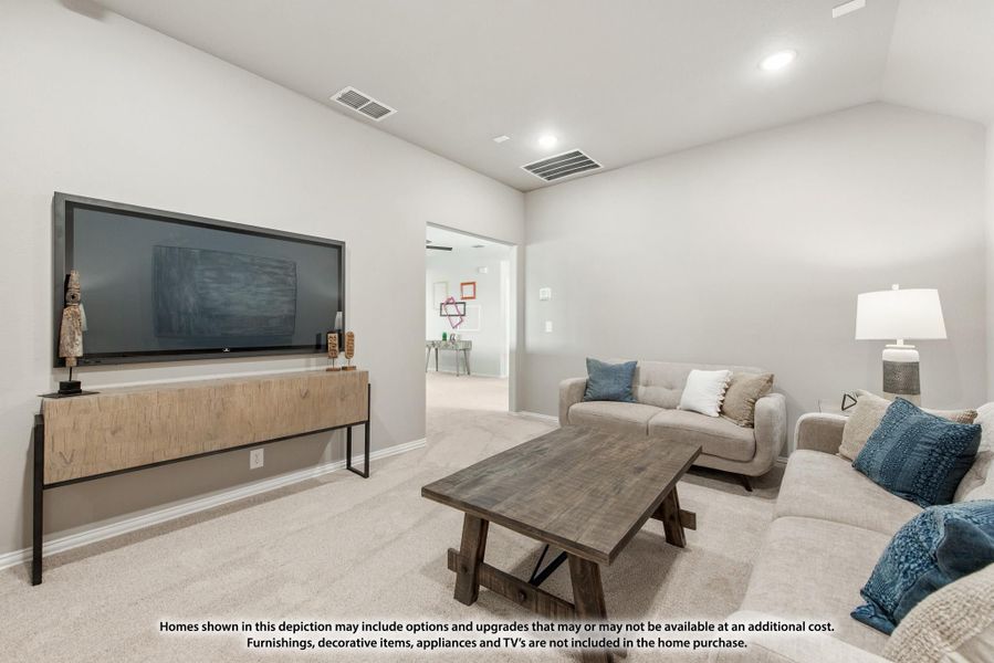 Living room with wall-mounted TV, wood media console, neutral sofa, and carpeted floors