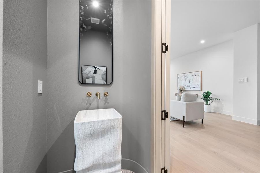 Bathroom with light wood finished floors and recessed lighting