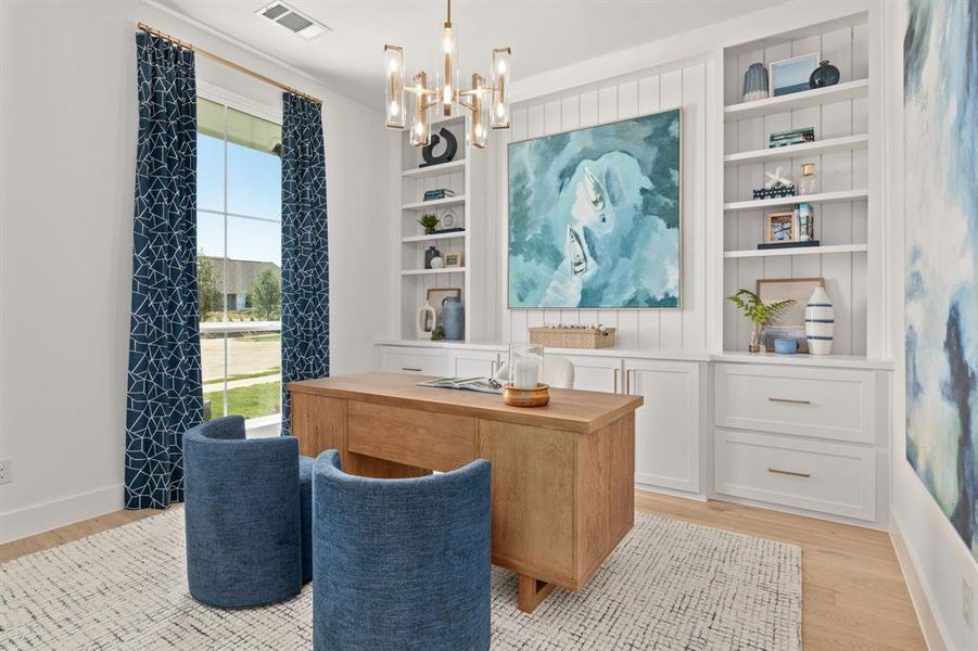 Office with built in features, light wood-style flooring, and a chandelier Office with built in features, light wood-style flooring, and a chandelier