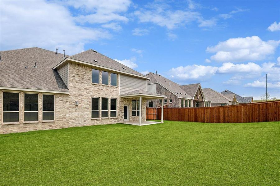 Back of house featuring a patio area and a yard