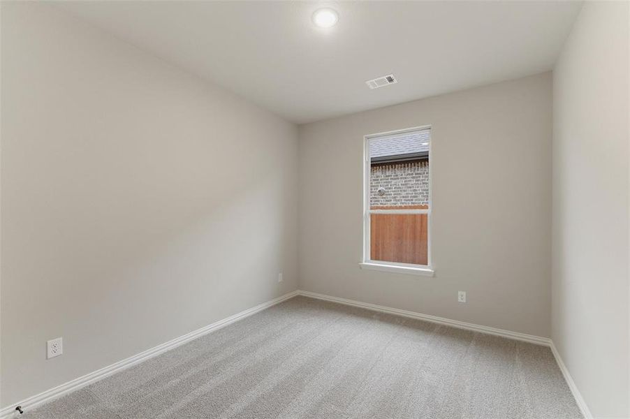 Room featuring light gray carpet flooring, neutral painted walls, and white trim