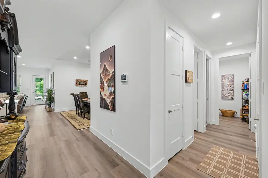 Upon entering the home, the hallway to the right contains a coat closet, one secondary bedroom, a full bathroom, utility room and entry door to the garage. Upon entering the home, the hallway to the right contains a coat closet, one secondary bedroom, a full bathroom, utility room and entry door to the garage.