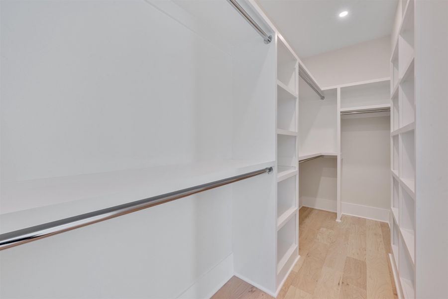 Primary Closet with Wood Shelving