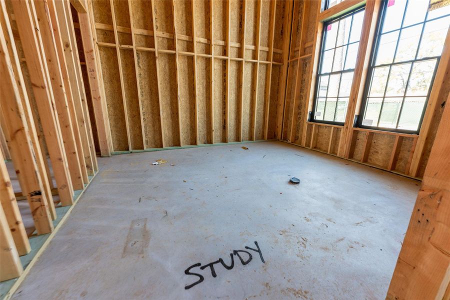 A dedicated space taking shape for productivity and pause, with generous windows inviting in soft daylight—an ideal setting for a refined home office or private library.
